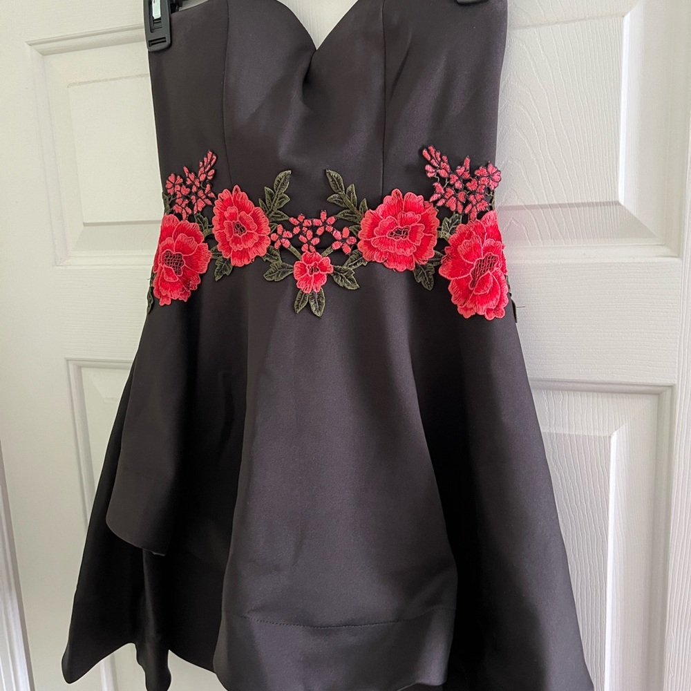 B. Smart Black Dress with Red Floral Accents